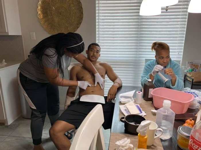 Chad Whitener having his dressing changed by nurse Sharise Lajuan. 